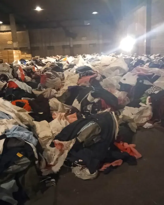 A mountain of second-hand clothing our team sorts through by hand