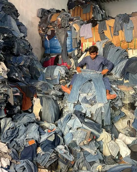 A mountain of second-hand clothing our team sorts through by hand