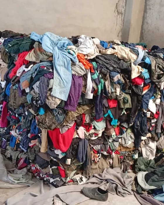 A mountain of second-hand clothing our team sorts through by hand