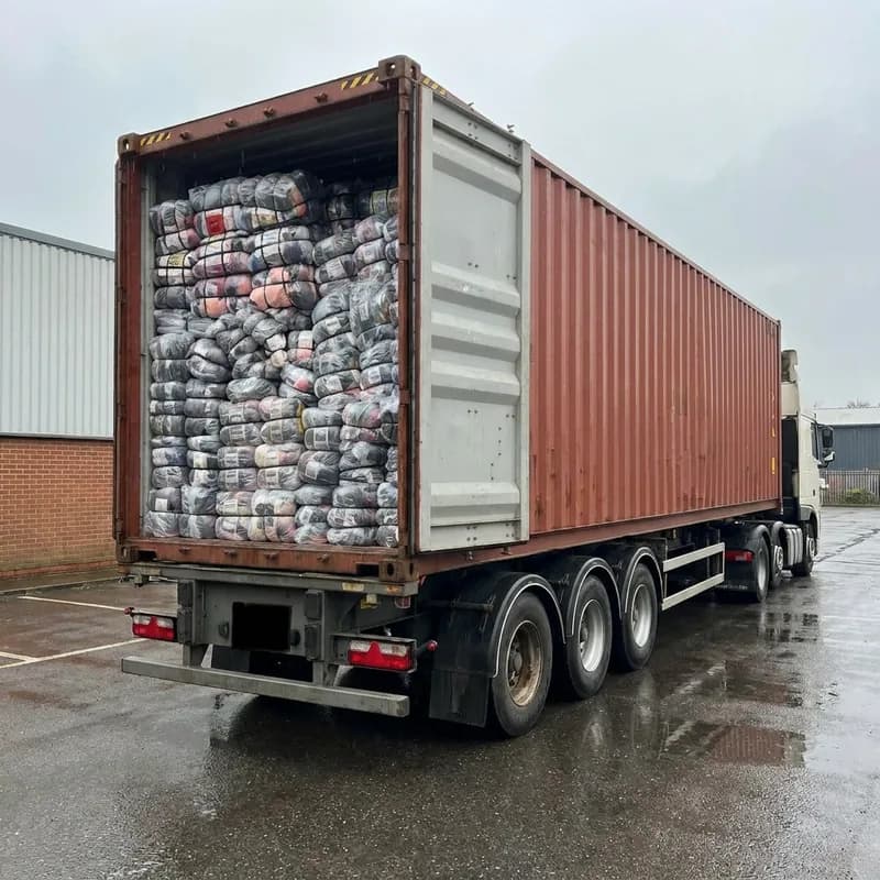 A full container of bales on the back of a lorry