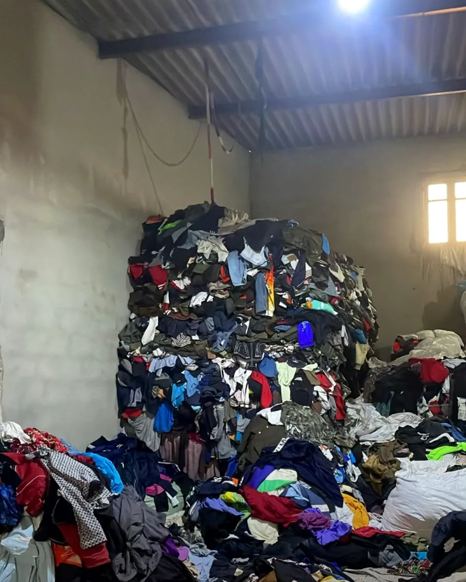 A huge pile of second-hand clothing in one of our Pakistan warehouses