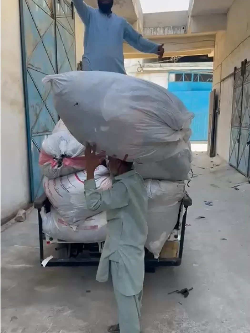 Bales being loaded onto a cart in Pakistan